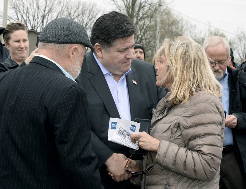 Illinois Gov. JB Pritzker meets with those attending a ceremony Thursday, April 28, 2022, honoring Steve Sutton who was shot and killed during a 1932 labor riot in Marseilles.