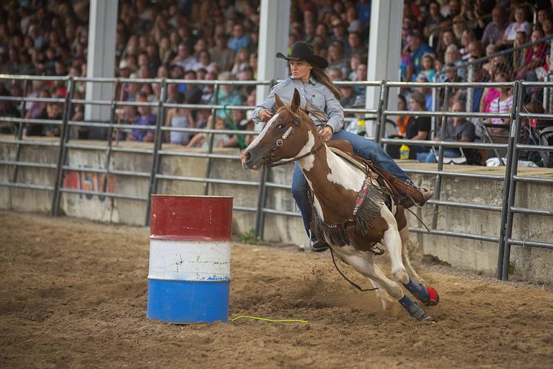 Natasha Napp rounds the first barrel in the barrel racing event Tuesday, August 16, 2022 during the Next Level Bull Riding tour at the Whiteside County fair.