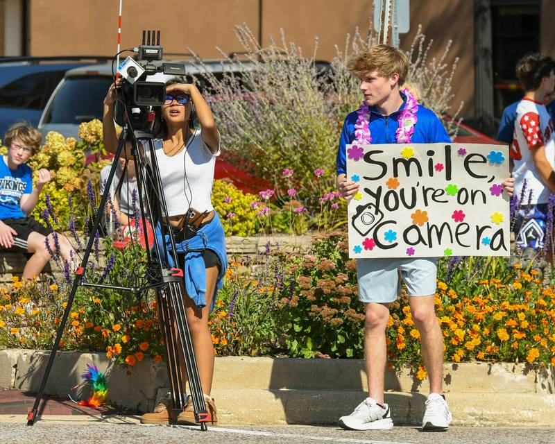 Geneva High School senior Matthew Hart and Jia Escoto, a junior, work together to film during the Geneva High School Homecoming Parade on Friday, Sept. 26, 2025, along State Street in downtown Geneva. The pair filmed for the high school's television program.