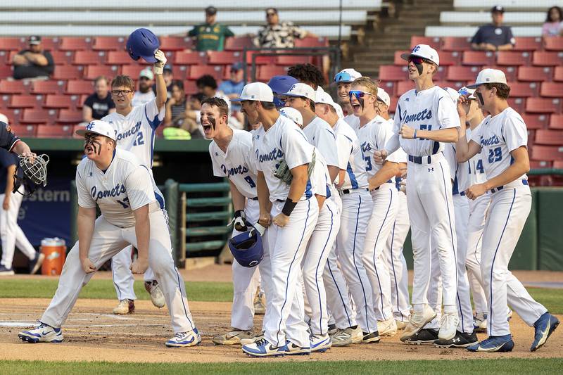 Newman teammates wait to celebrate Daniel Kelly’s first inning home run against Chicago Hope Monday, June 2, 2025, during the Class 2A Supersectional at Northwestern Medicine Field in Geneva.