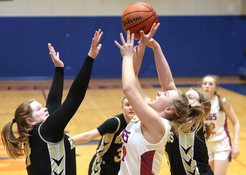 Genoa-Kingston's Emily Trzynka goes up for a shot between two Rockford Christian defenders during their game Friday, Jan. 13, 2023, at Genoa-Kingston High School.
