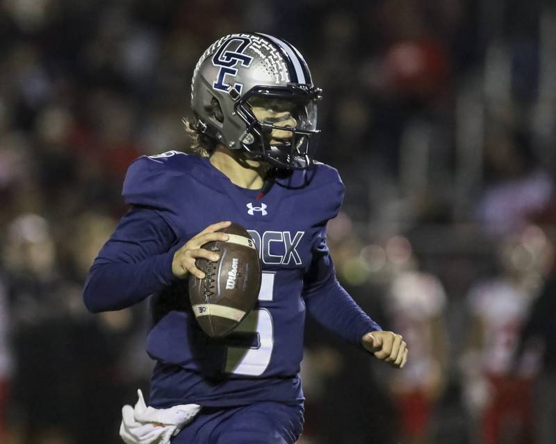 Oswego East's Nickolas Villacci (5) looks for an open receiver during football game between Yorkville at Oswego East Friday, Oct 10, 2025 in Oswego.