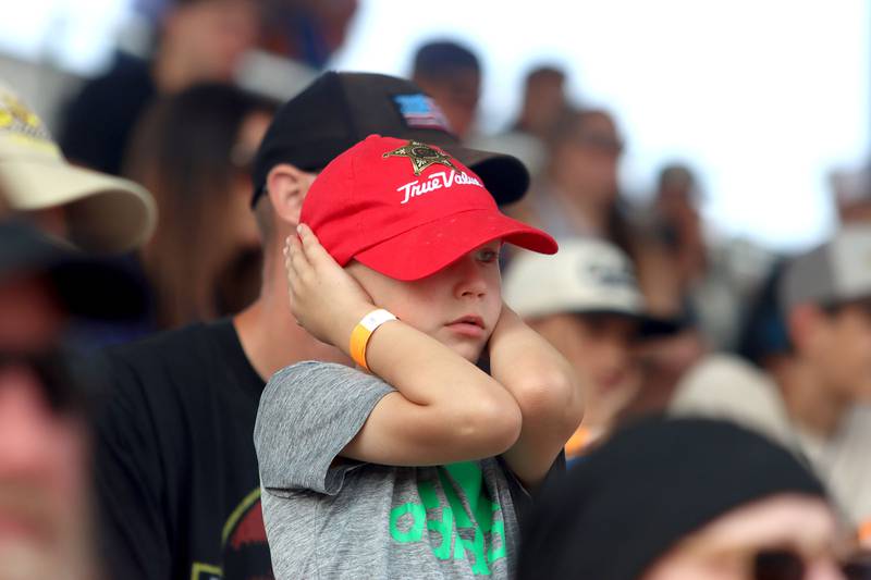 Ben Mertes, 5, of Cary holds his ears as tractors rev and pull sleds down the track on the final day of the 2025 McHenry County Fair in Woodstock on Sunday, August 3, 2025. “The tractors are cool,” said Mertes, “I like it when they do wheelies.”