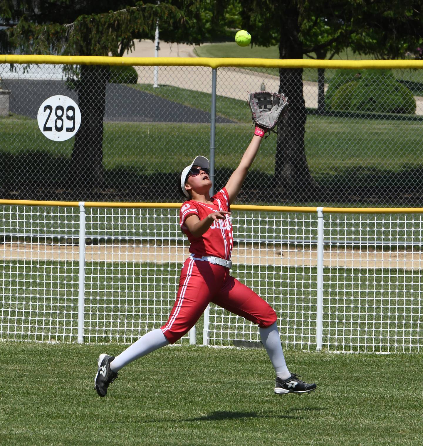 Oregon centerfielder Giselle Zavala stretches to make the catch as she chases down a Rock Falls' fly ball for an out during the championship game at the 2A Oregon Regional on Saturday, May 23, 2026 at Oregon Park West.