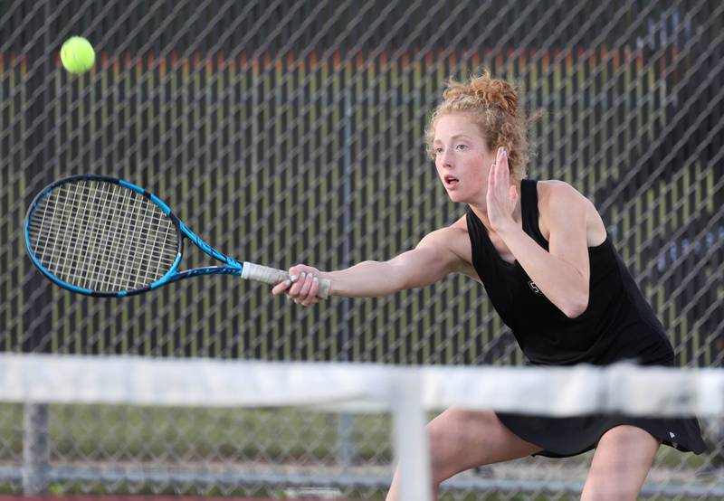 Sycamore’s Jordyn Telstra returns a serve during her match against DeKalb Wednesday, Sept. 13, 2023, at DeKalb High School.