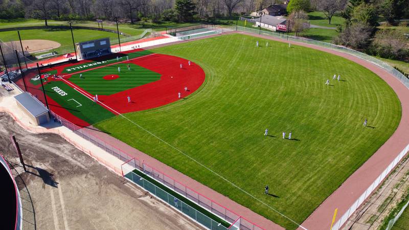 Yorkville baseball players warm up on their new turf baseball field prior to the start of their game against West Aurora at Yorkville High School on Monday, April 15, 2024.