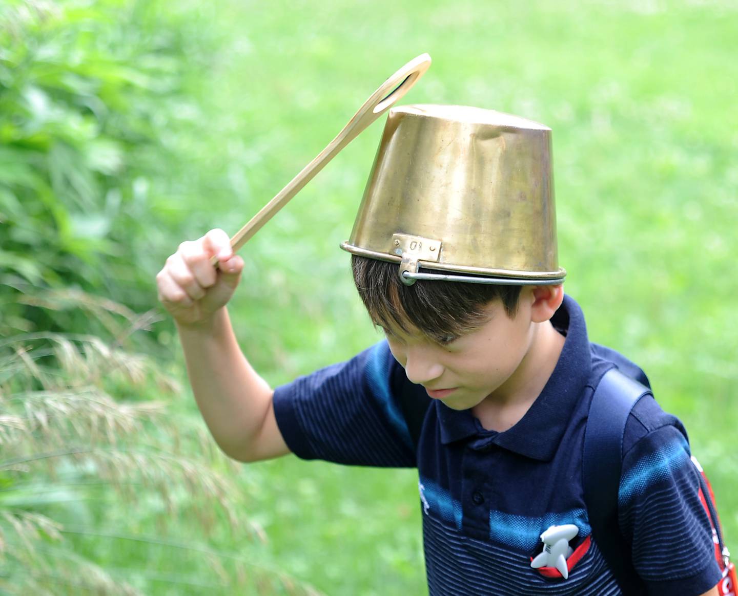 Josthin Meiga, 8, bangs the makeshift drum on his head as children from Youth and Family Center of McHenry County summer camp program play the drums Wednesday, July 6, 2022, during a field trip to the Harrison Benwell Conservation Area, 7055 McCullom Lake Road in Wonder Lake. The Youth and Family Center of McHenry County is hiring a social worker to assist with the mental health needs of those they help. The nonprofit is one of three receiving funds through United Way of Greater McHenry County as part of an Advance McHenry County grant.