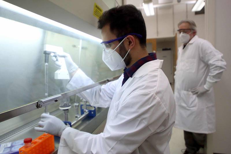 Director of COVID-19 Facilities Dr. Barrie Bode and Research Associate Syed Hyder test processes in the laboratory at Montgomery Hall on the campus of Northern Illinois University in DeKalb. The various chemical and physical processes the two are testing will be used to gauge the presence of the COVID-19 virus in wastewater samples.