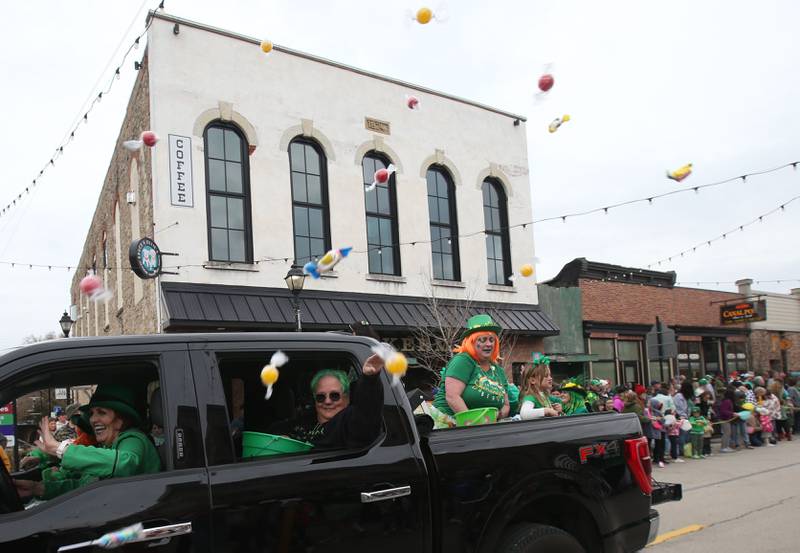 People throw candy during the St. Patrick's Day parade on Saturday, March 15, 2025 downtown Utica.