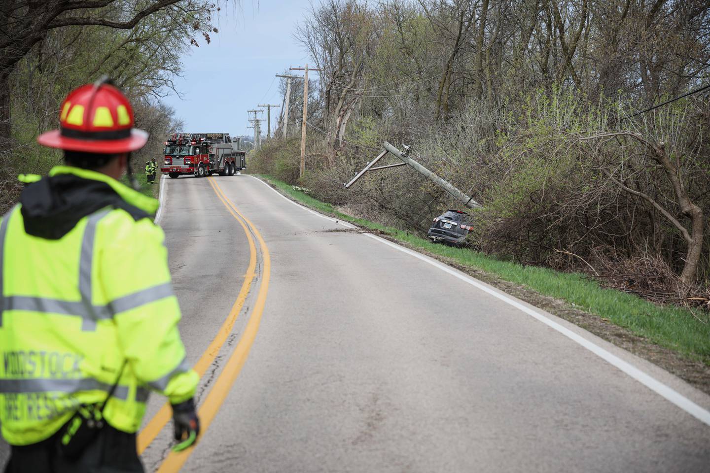 The Woodstock Fire/Rescue District responds to a crash involving a single car and a utility pole Wednesday, April 23, 2025 to the intersection of Country Club Road and Bull Valley Road in Woodstock.