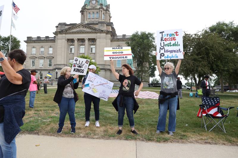 Protesters hold signs along East Court Street during a "Good Trouble Lives On" rally held in Kankakee as part of a national day of peaceful protests on Thursday, July 17, 2025.