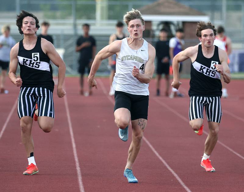 Sycamore’s Aidan Wyzard runs just ahead of Kaneland’s Dylan Sanagustin (left) and Kaneland's Benjamin Karl in the 100 meters Tuesday, May 13, 2025, during the Interstate 8 Conference boys track championships at Rochelle High School. Wyzard would go on to win the event with Sanagustin finishing in second.