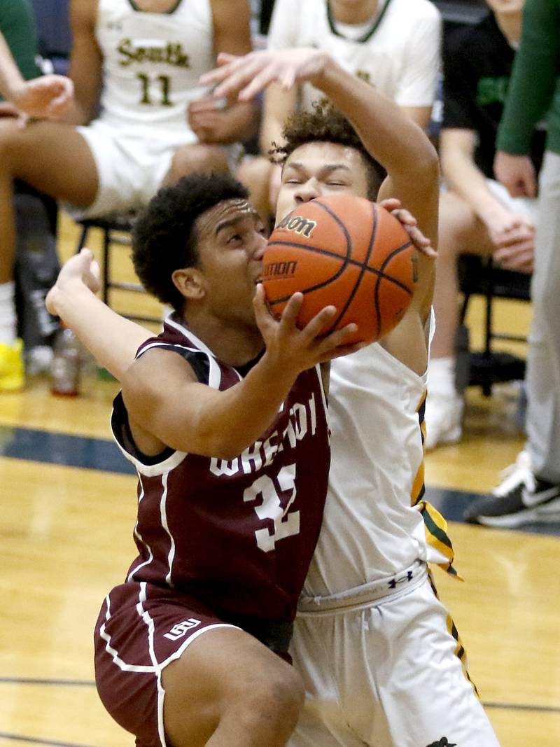 Wheaton Academy's Wandy Munoz drives to the basket against Crystal Lake South's Cooper Buelna during the IHSA Class 3A Cary-Grove Boys Basketball Regional Championship game on Friday, Feb. 23, 2024 at Cary-Grove High School.
