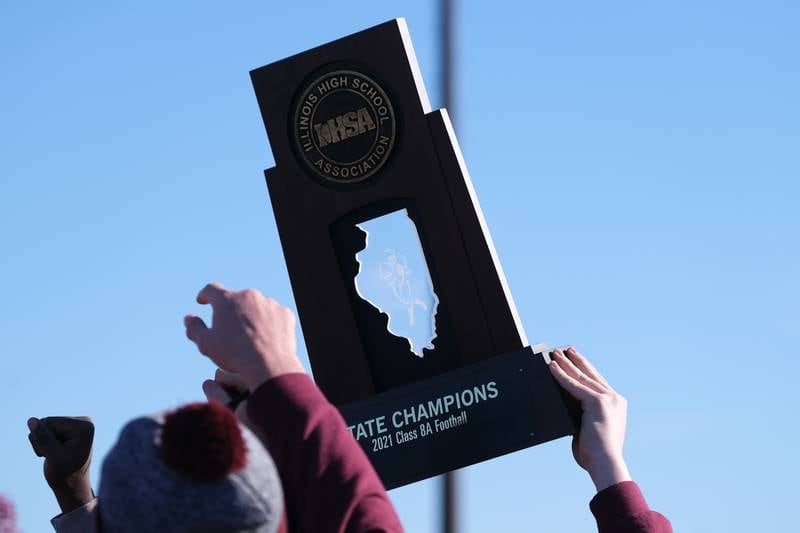 Lockport players hold up the Class 8A championship trophy at Lockport Township High School East Campus. Sunday, Nov. 28, 2021 in Lockport.