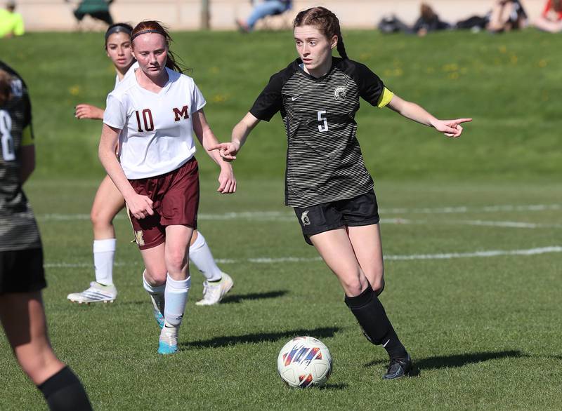 Sycamore's Grace Parks dribbles the ball ahead of Morris' Danica Martin during their Interstate 8 Conference Tournament semifinal game Wednesday, May 3, 2023, at Sycamore High School.