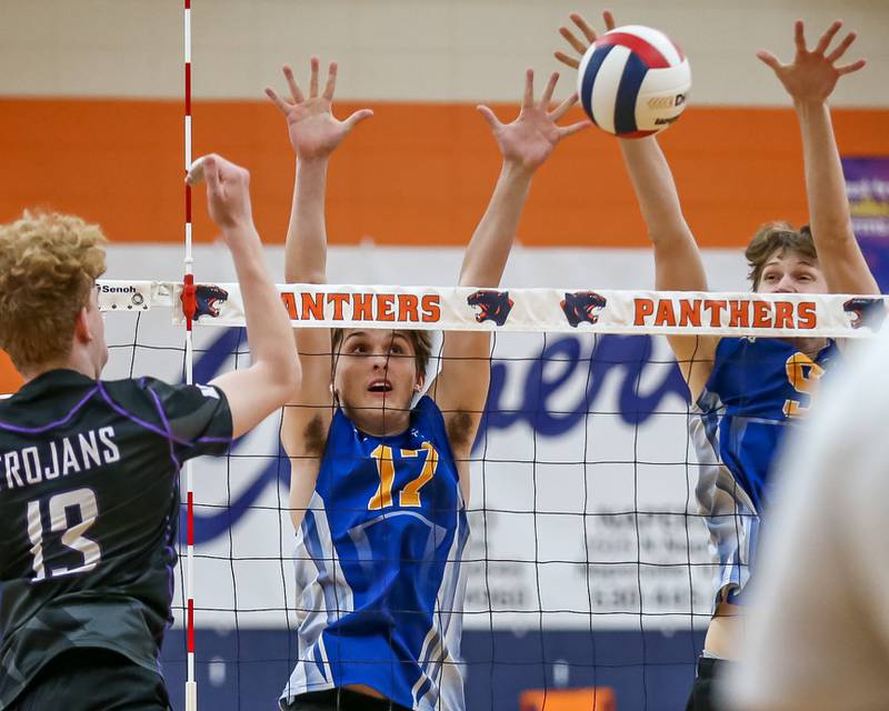 Lyons Carson Turner (17) and Leo Wiemelt (9) attempt a block at the net on Downers Grove North's Cooper Hansen's (13) smash during Oswego Sectional final between Downers Grove North at Lyons.  May 30, 2023.
