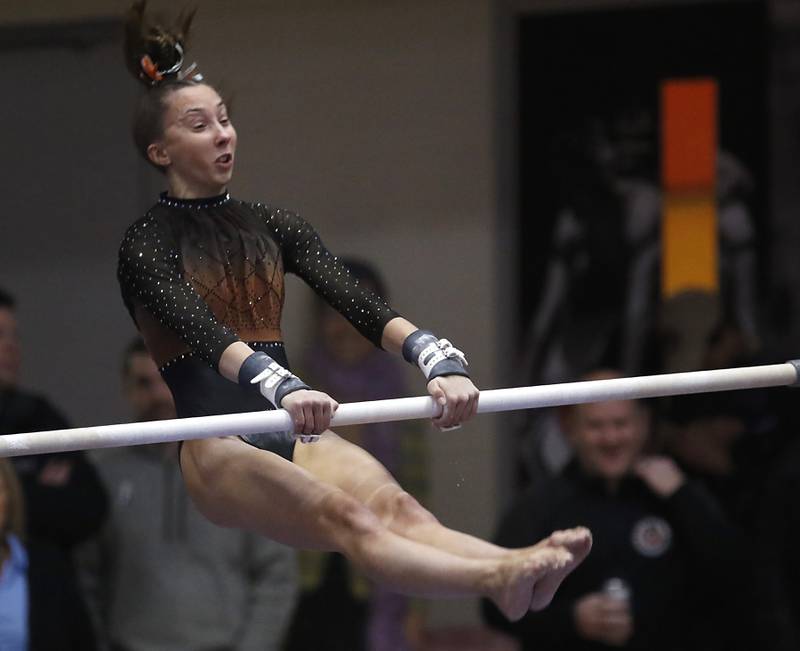 Libertyville’s Anna Baker competes in the of the uneven parallel bars Friday, Feb. 17, 2023, during the IHSA Girls State Final Gymnastics Meet at Palatine High School.