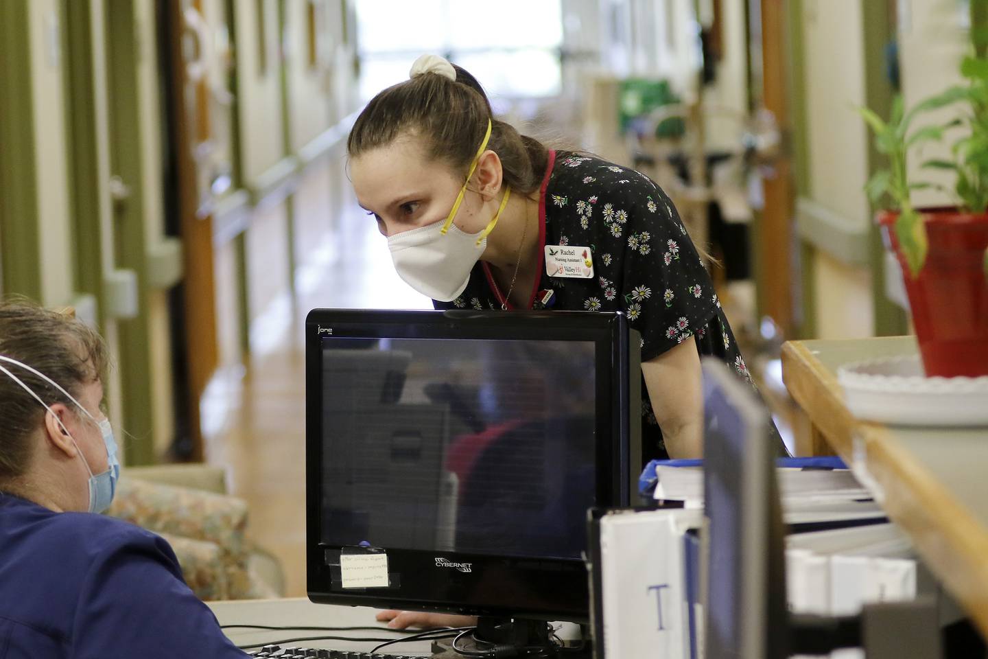 Rachel Reddick, CNA, talks with a colleague at the nurses station at Valley Hi Nursing Home on Tuesday, Aug. 17, 2021 in Woodstock.