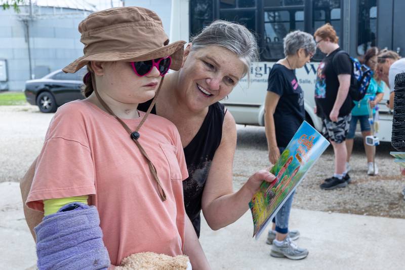 Michelle of lighted way shows student Mackenzie book gifted by Laura Loch on Friday, June 27, 2025 at Loch Countryside Kennel in Peru.