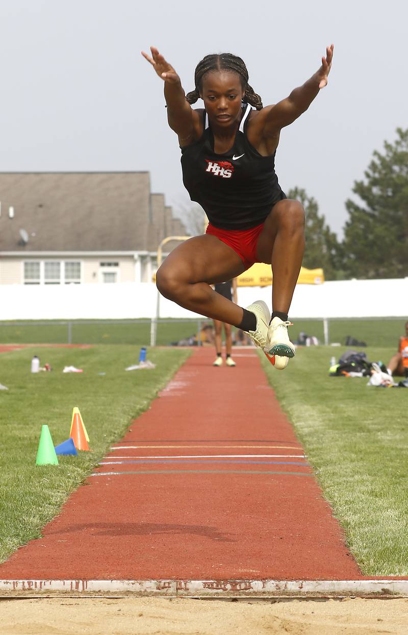 Huntley’s Alex Johnson flies as she competes in the triple jump during the IHSA Class 3A Huntley Girls Track Sectional Wednesday,  May 11, 2022, at Huntley High School.