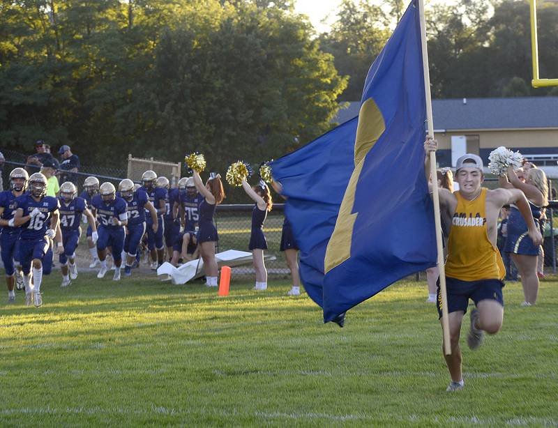 The Marquette Crusaders take the field for their home opener Friday against Madison.