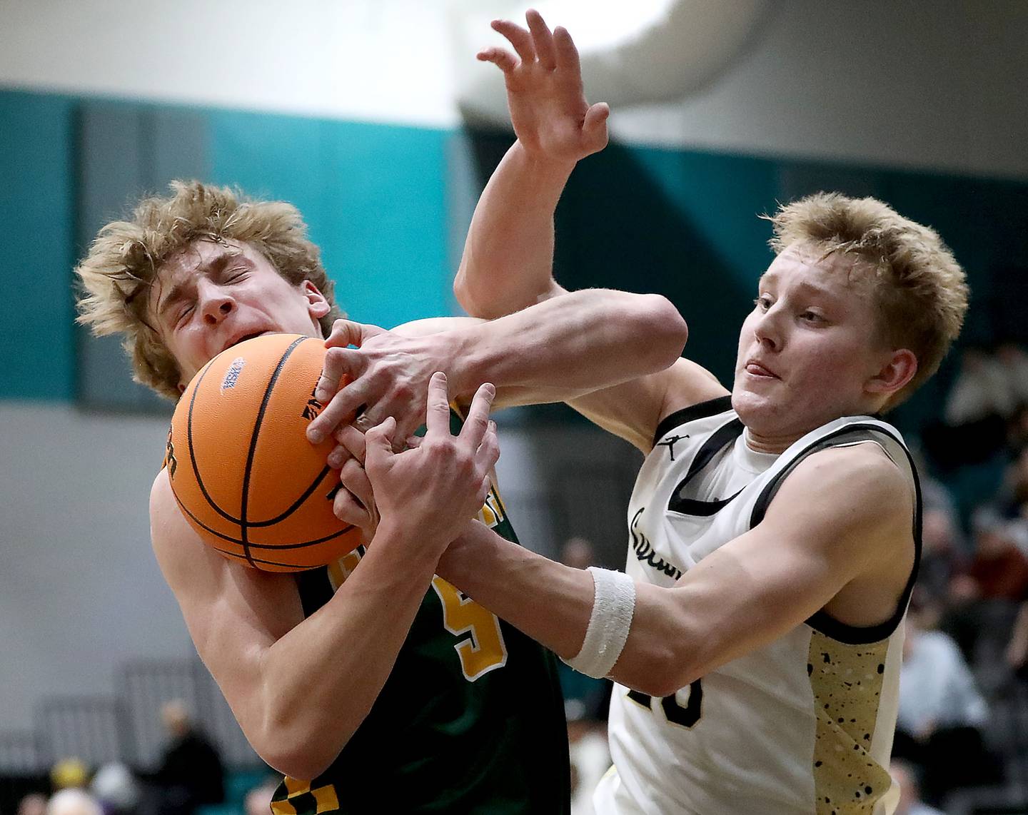 Crystal Lake South's Carson Trivellini battles with Sycamore's Isaiah Feuerbach during an IHSA Class 3A Woodstock North Sectional semifinal.basketball game on Wednesday, March 4, 2025, at Woodstock North High School.