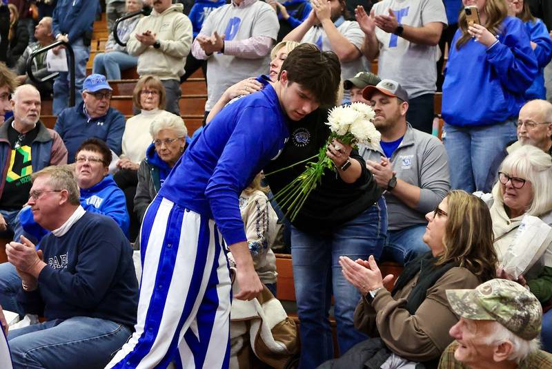 Princeton senior Noah LaPorte hugs Tiger mom Heathe Mason before Friday's game at Prouty Gym. Her husband,  Jackson's dad, Pat, passed away unexpectedly on Monday.  PHS took a moment of silence in Pat's honor.