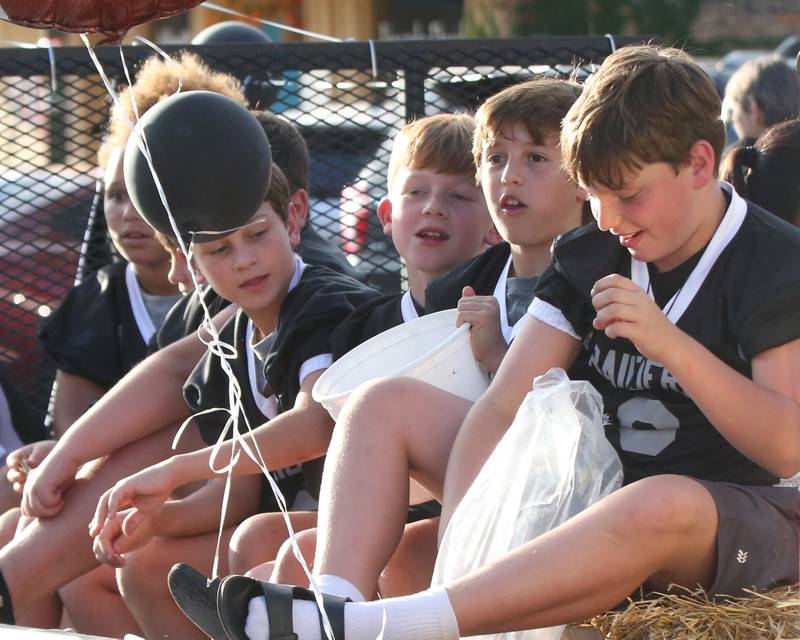 Spring Valley flag football players ride a float during the Hall High School Homecoming parade on Thursday, Sept. 28, 2023 in Spring Valley.