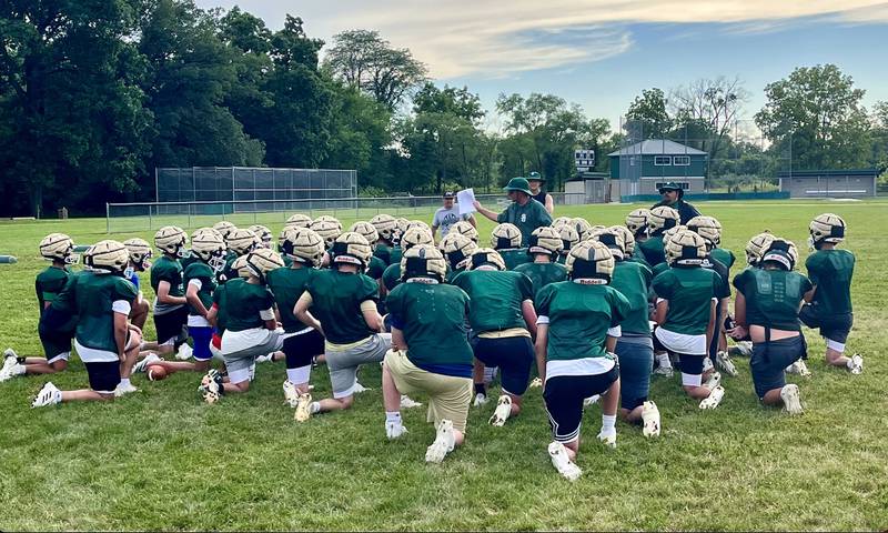 St. Bede football coach Jack Brady talks to his team after a workout in July.