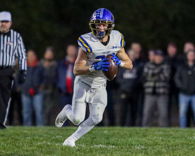 Moroa-Forsyth's Kaiden Maurer (22) rolls out before flipping the ball to a receiver during Class 2A semi-final playoff football game between Moroa-Forsyth at Wimington.  Nov 18, 2023.