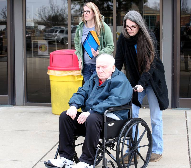 Chester Weger (in the wheelchair) escorted by  members of his, Weger's family, exits the La Salle County courthouse after a hearing before Judge Michael C. Jansz on Friday, Feb. 24, 2023 in Ottawa.