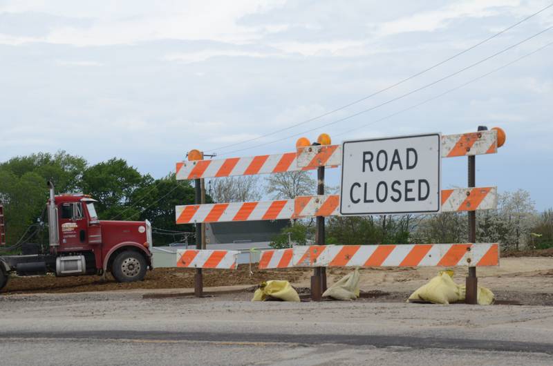Construction crews work on the Eldamain Road and bridge extension beyond a blockade on U.S. Route 71. (Lucas Robinson - lrobinson@shawmedia.com)