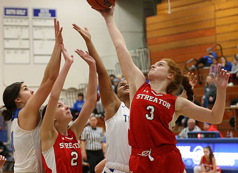 Streator's Ellie Isermann (3) grabs a rebound over Princeton defenders Olivia Gartin (11) and Mariah Hobson (12) in the Lady Tigers Holiday Tournament on Tuesday, Nov. 15, 2022 in Princeton.