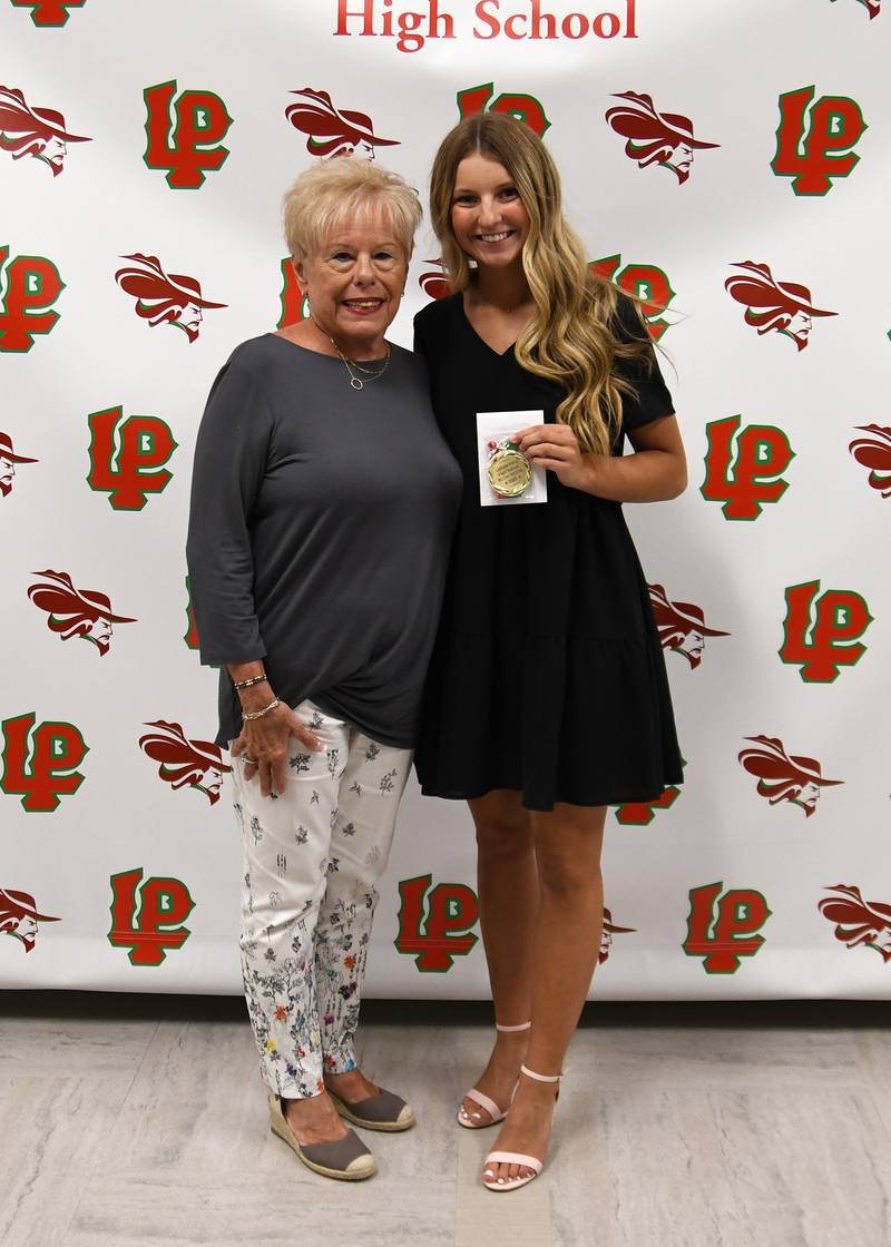 Taylor Martyn (right) received the George Preston Blow Medal/John & Lucy Pomatto Scholarship, presented by Jane Riva (left). The $1,500 scholarship is considered the highest award the La Salle-Peru High School athletics department bestows. Candidates are nominated by varsity head coaches and voted on by L-P administrators.