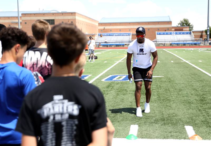 Former St. Charles North standout and current New York Giants defensive back Tyler Nubin works with young players on the first day of a three-day football camp on Friday, June 20, 2025 in St. Charles.