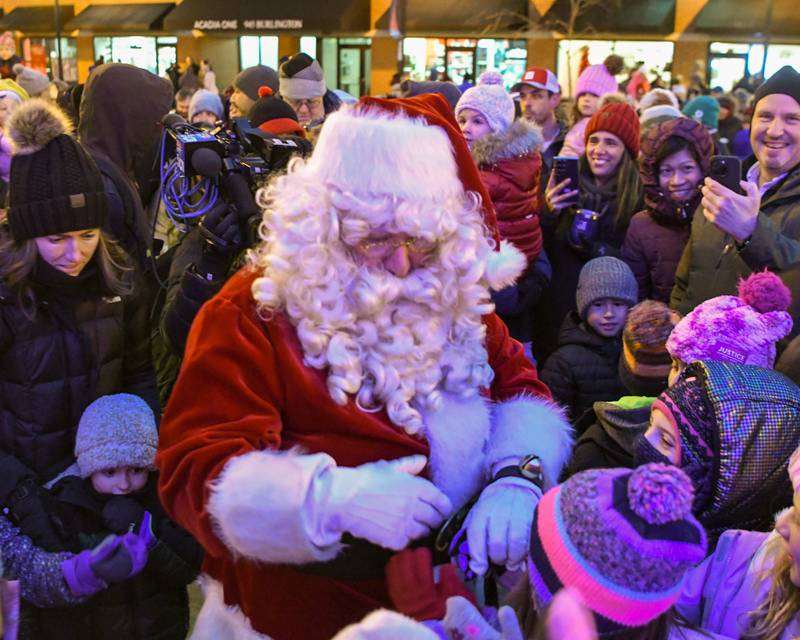 Santa Clause greets young fans after the Christmas tree lighting ceremony on Friday Nov. 29, 2024, in downtown Downers Grove.