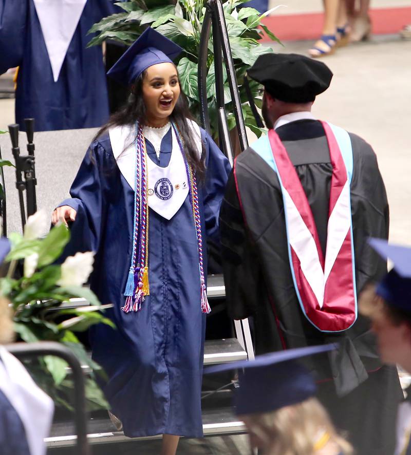 An Oswego East senior receives her diploma on May 21, 2022 in DeKalb.