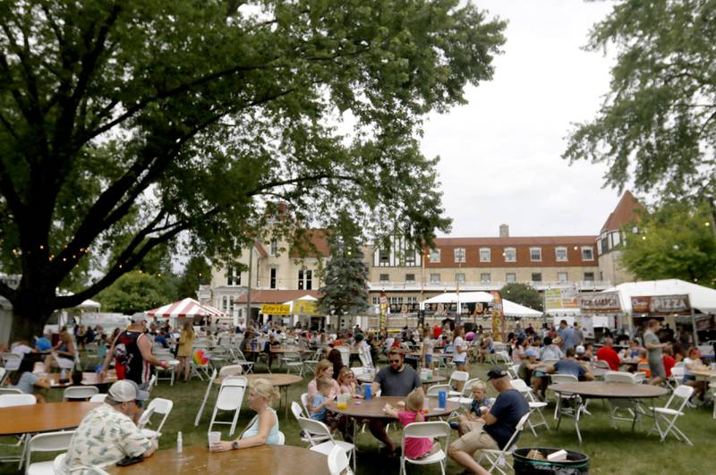 People enjoy the afternoon with food and drinks Friday, July 1, 2022, during Lakeside Festival at the Dole and Lakeside Arts Park, 401 Country Club Road in Crystal Lake.