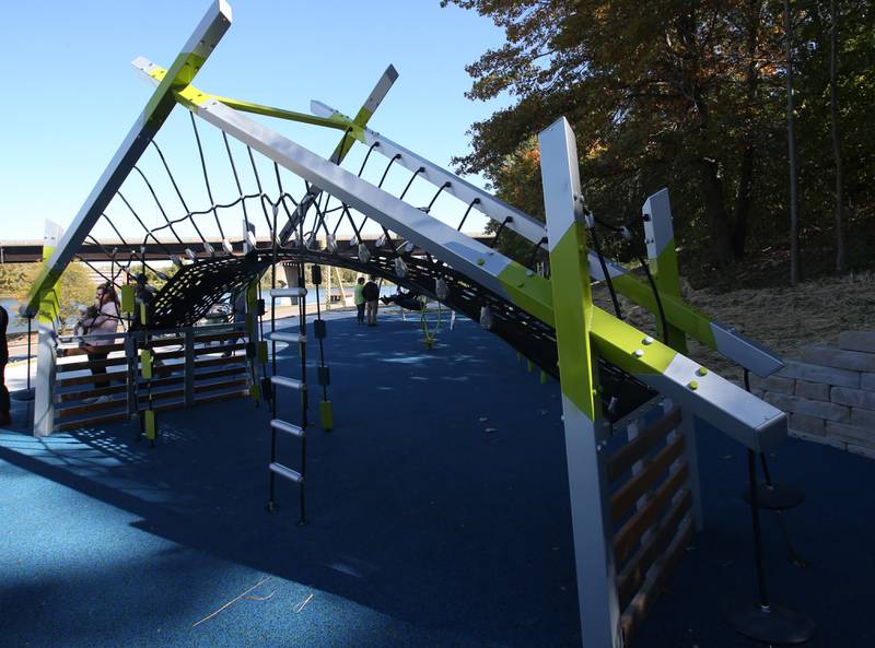 A view of the new playground equipment during The City of Ottawa ribbon-cutting ceremony on Thursday, Oct. 17, 2024 at Allen Park in Ottawa. Commissioner Marla Pearson (center) cuts the ribbon on a 1.5 million dollar completion of a playground and other improvements to the park. The project was partially funded by a $506,000 IDNR Open Space Land Acquisition and Development grant. The new enhancements to Allen Park include accessible sidewalks leading to the upper plateau, featuring a modern playground and hillside play area with safe, poured-in-place surface for children of all abilities. The area also includes a shelter, bench swing with views of the Illinois River and a stone council ring for relaxation and community gatherings. 
A paved quarter-mile looped walking trail along the scenic banks of the Illinois River, two designated gaming areas, one with four bag toss stations and another with two chess-checkers tables and two ping-pong tables, all designed to promote social interaction and recreation. The sculptures will be repainted in the spring of 2025.
