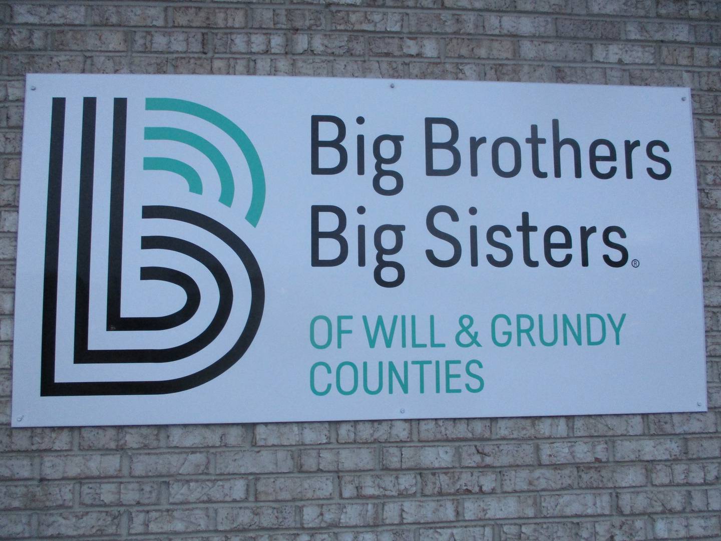 The Big Brothers Big Sisters of Will & Grundy Couties logo is posted on a sign outside its office building at 14 Fairlane Drive in Joliet. Jan. 4, 2024.