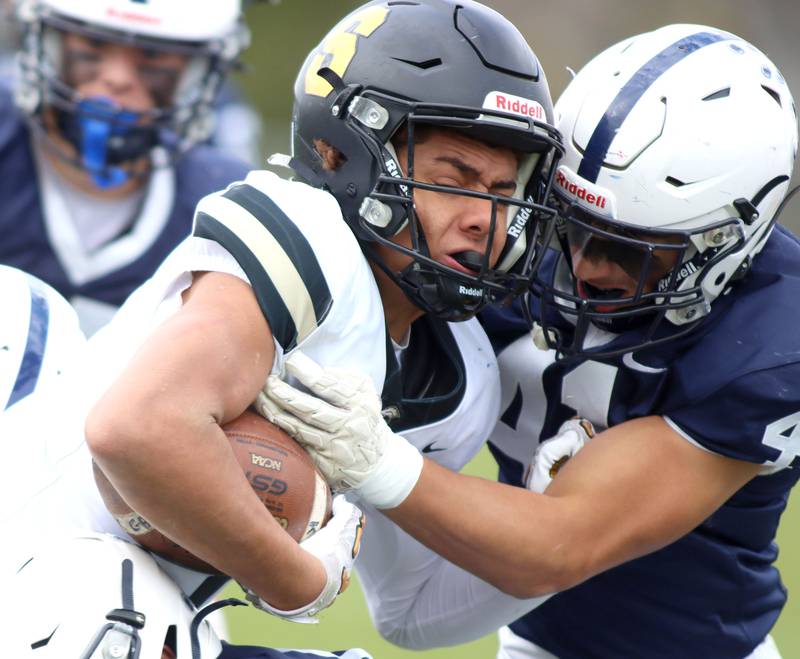 Cary-Grove’s Nate Jonas, right, hits Sycamore’s Josiah Mitchell in IHSA football Class 5A first-round playoff action at Al Bohrer Field on the campus of Cary-Grove High School in Cary on Saturday, November 1, 2025.