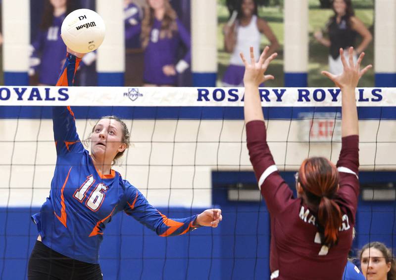 Genoa-Kingston's Alayna Pierce spikes the ball past a Marengo player Thursday, Oct. 27, 2022, during their Class 2A Regional final match at Rosary High School in Aurora.
