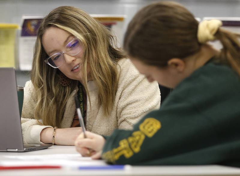 Hailey Baker, the college and career advisor at Crystal Lake South High School, helps senior Meg Norten fill out a scholarship application Thursday, Jan. 26, 2023, at the school in Crystal Lake. This year's senior class is made up of students who began their high school careers dealing with COVID-19.