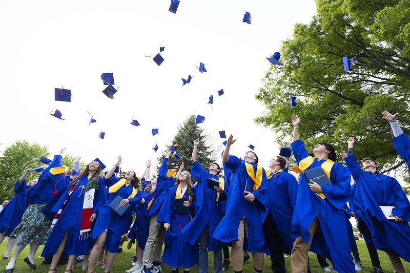 The Newman High School class of 2023 fires the hats in the air Wednesday, May 17, 2023 following their commencement.