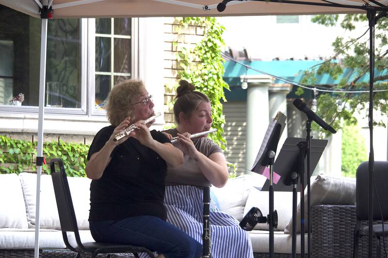 Members of the Joliet Symphony Orchestra play flutes in the 600 block of Western Avenue in Joliet as part of the Porch and Park Music Fest on Saturday, Aug. 16, 2025.