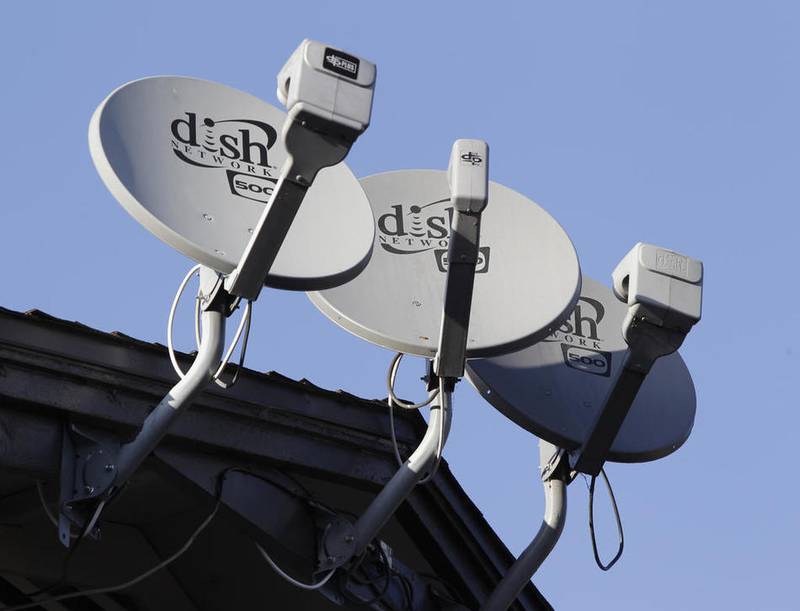 FILE - This 2011 file photo shows three Dish Network satellite dishes at an apartment complex in Palo Alto, Calif.