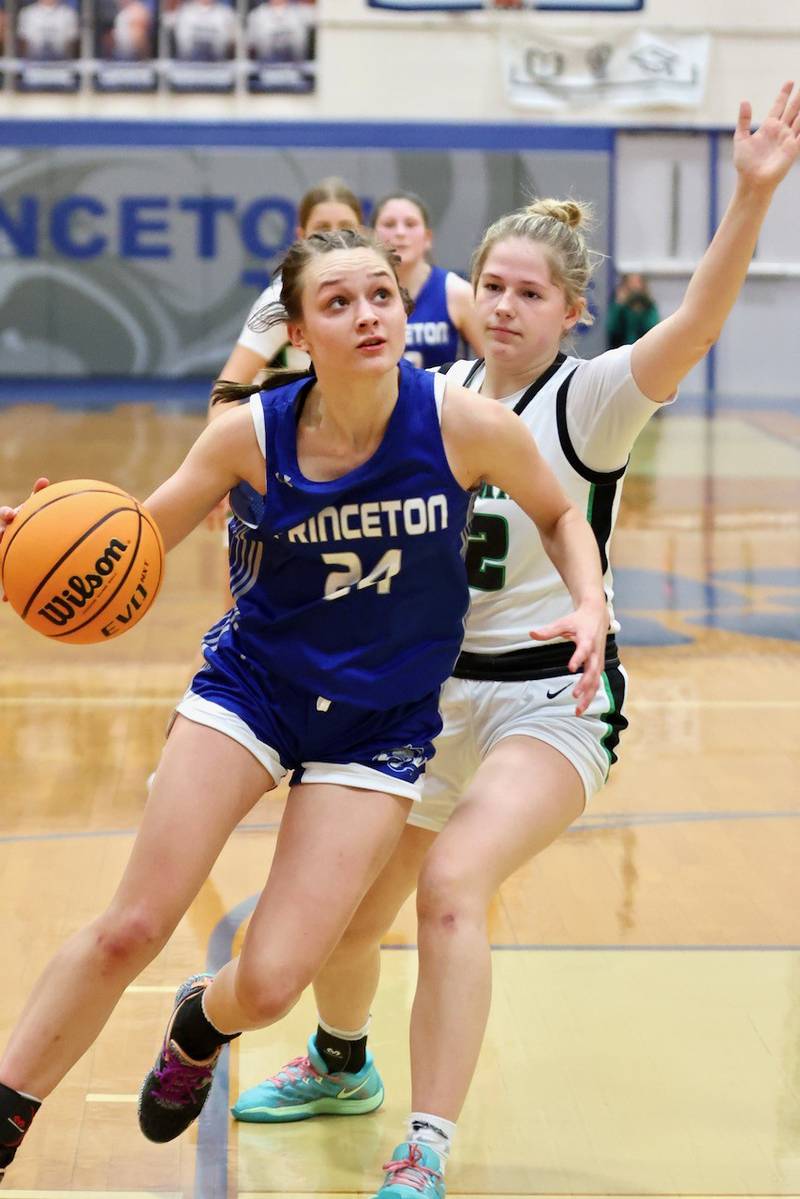 Princeton's Keighley drives by Alleman's Megan Hulke in Thursday's regional championship game at Prouty Gym. The Pioneers won 40-27.