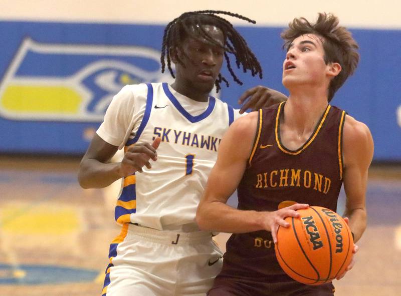 Richmond-Burton’s Dane Gardner, right, works under the hoop as Johnsburg’s Jarrel Albea defends in varsity boys basketball onTuesday, Dec. 9, 2025, at Johnsburg High School in Johnsburg.