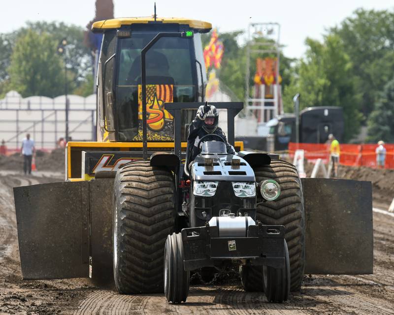 A tactor pull driver celebrates after completing his pull on Saturday Aug. 16, 2025, at Elburn Days.
