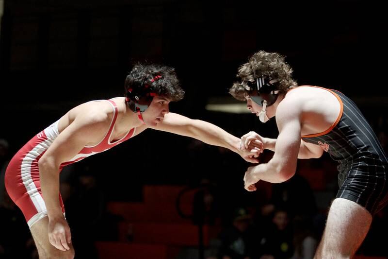 Crystal Lake Central’s Tyler Porter, right, battles Huntley’s Alex Napientek in a 165-pound bout in varsity wrestling at Crystal Lake Friday.  Napientek won the match.